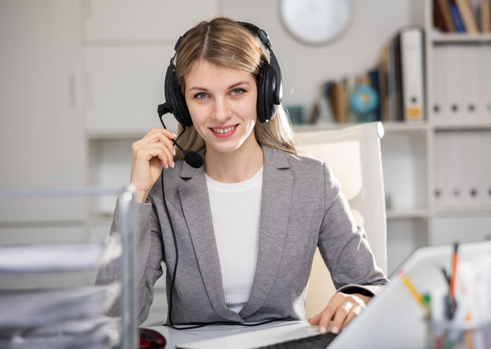 Call center woman operator with headset talking with client