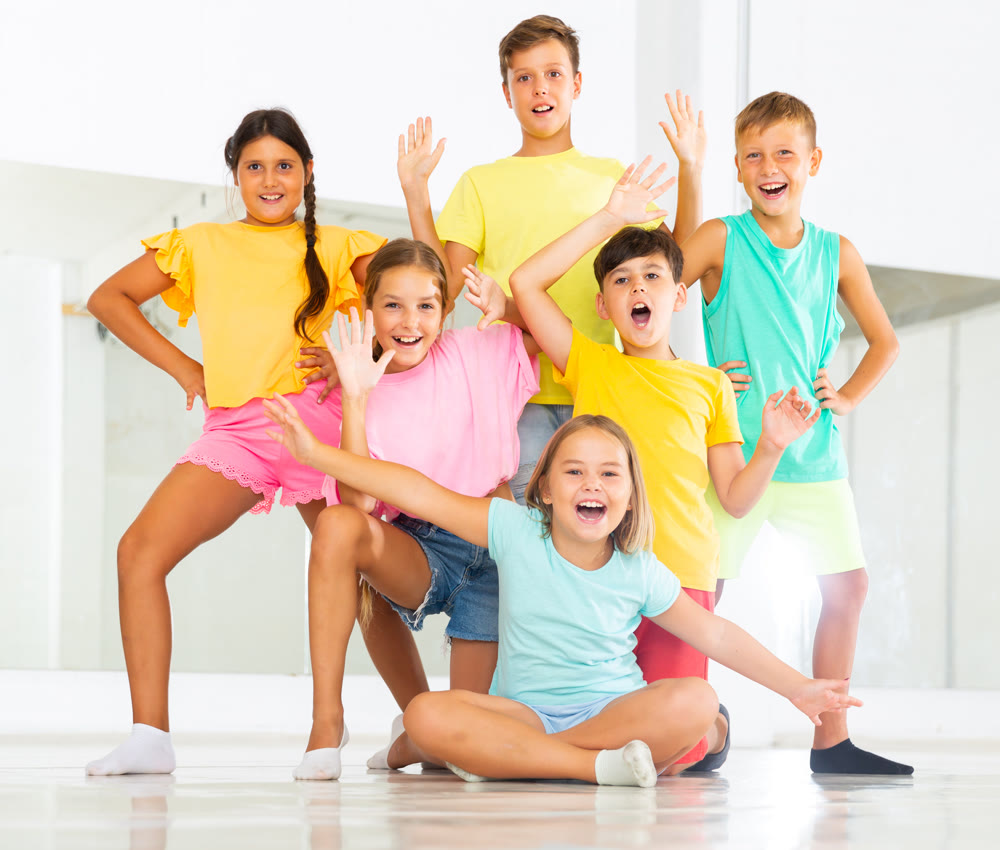 Happy children posing at modern dance class