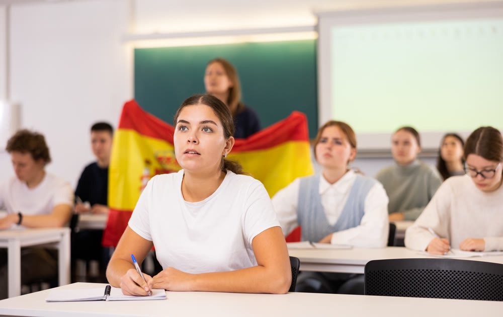 Young girl student diligently studies at school