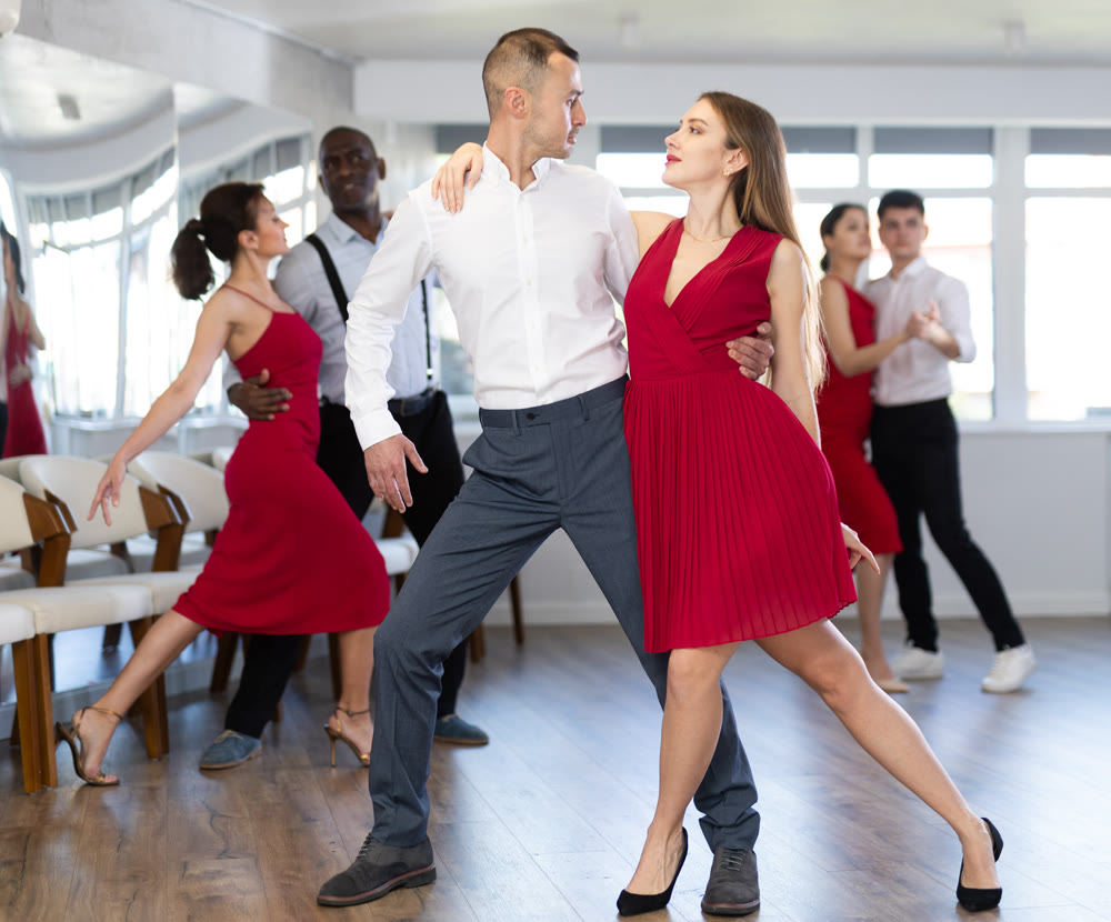 Adult man and young woman dancing tango