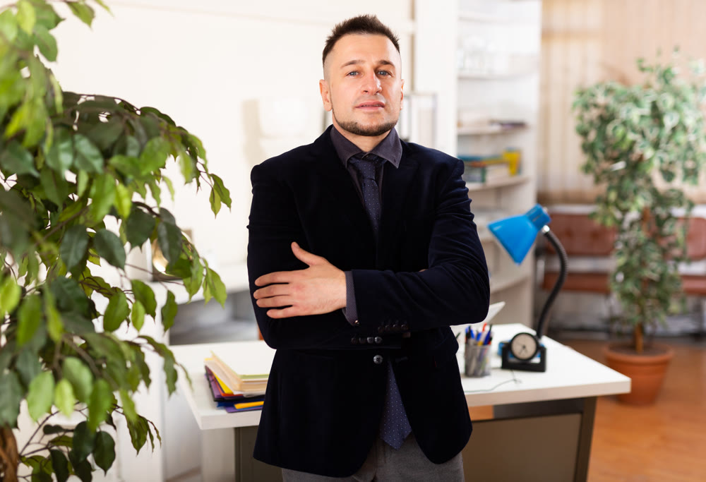 Confident young man working at office