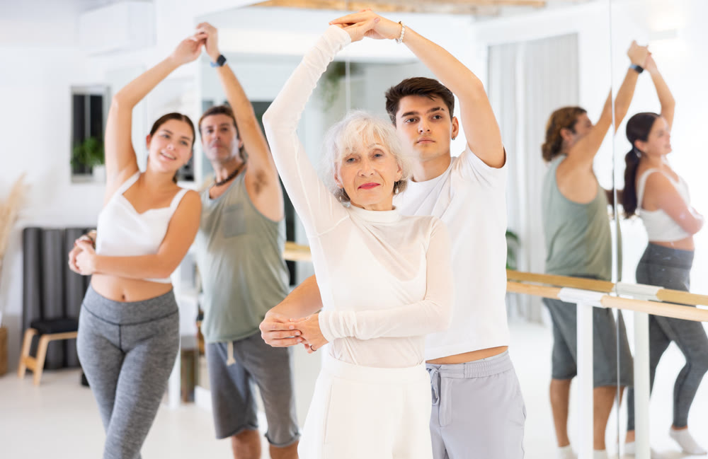 Men and women dancing in pairs during training session
