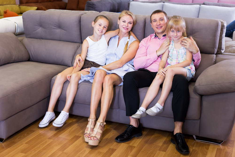 Family choosing sofa in store