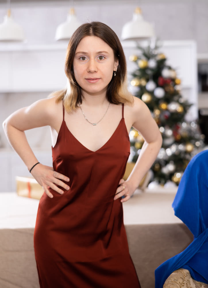 Young woman poses in a new festive dress