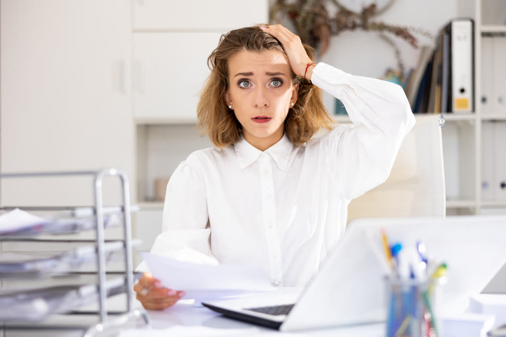 Tired businesswoman working with documents in office at table