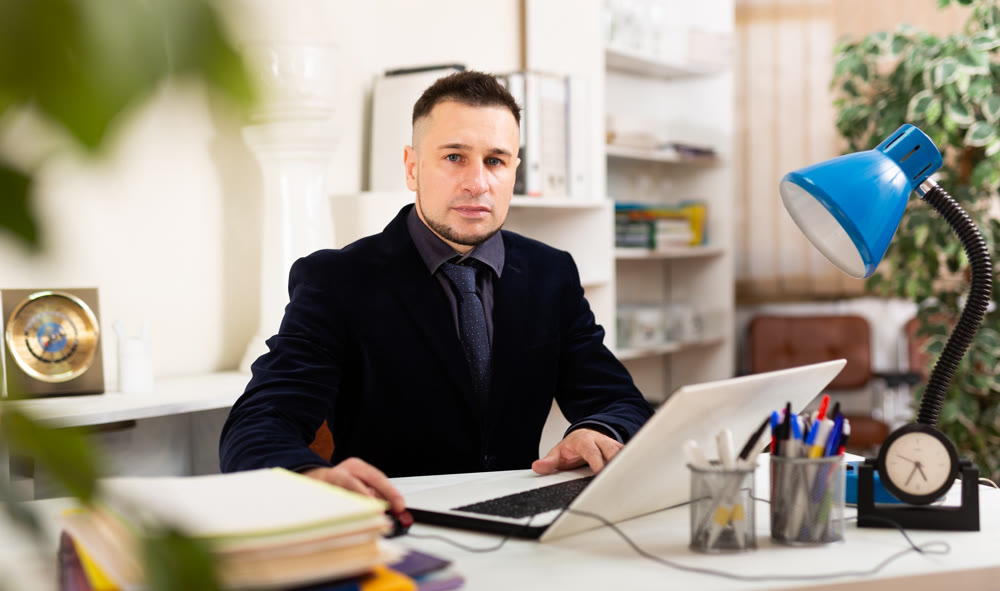 Confident young man working at office