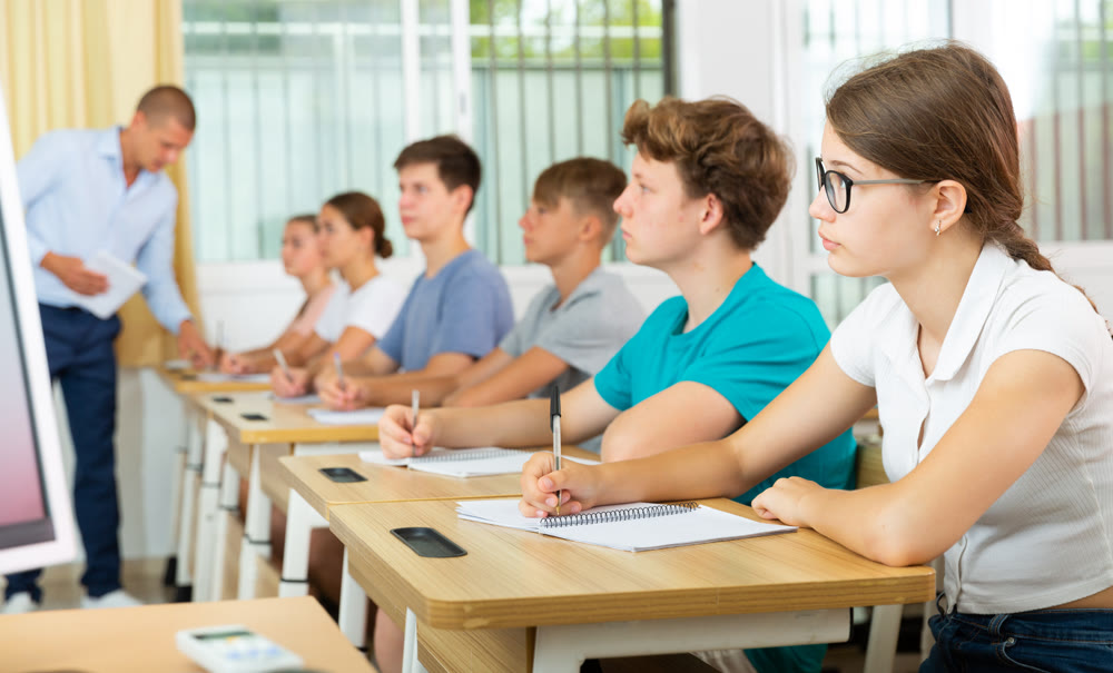 Pupils sitting in class and listening