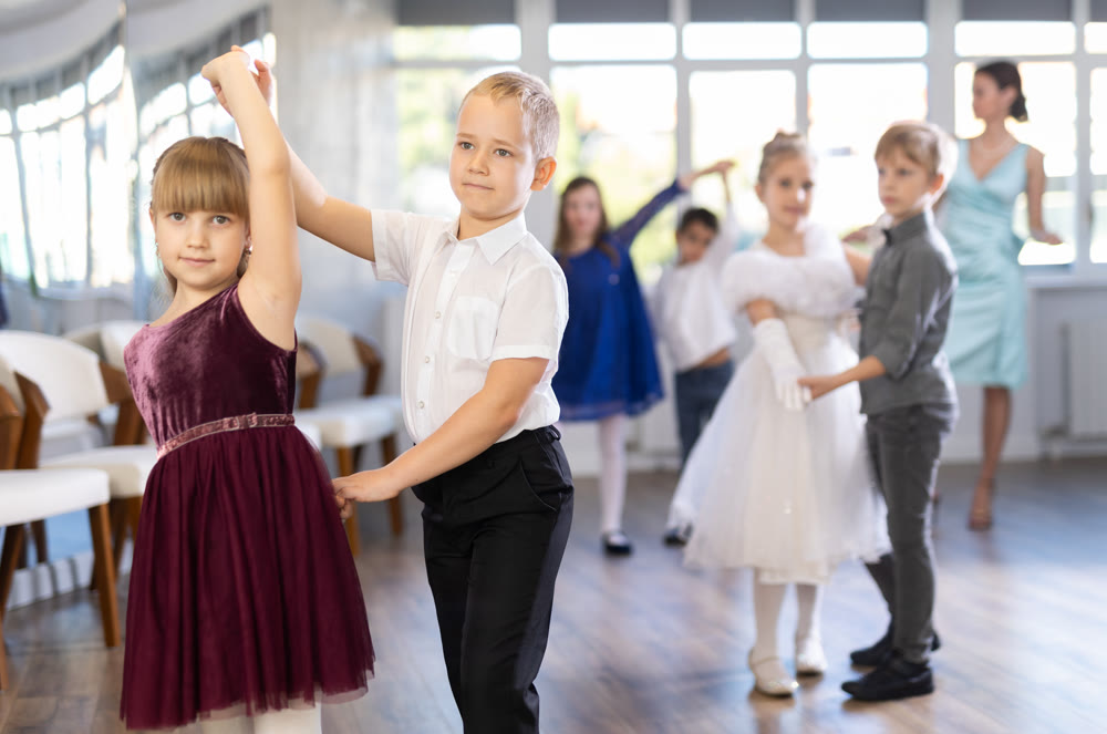 Children dance in pairs at festive matinee