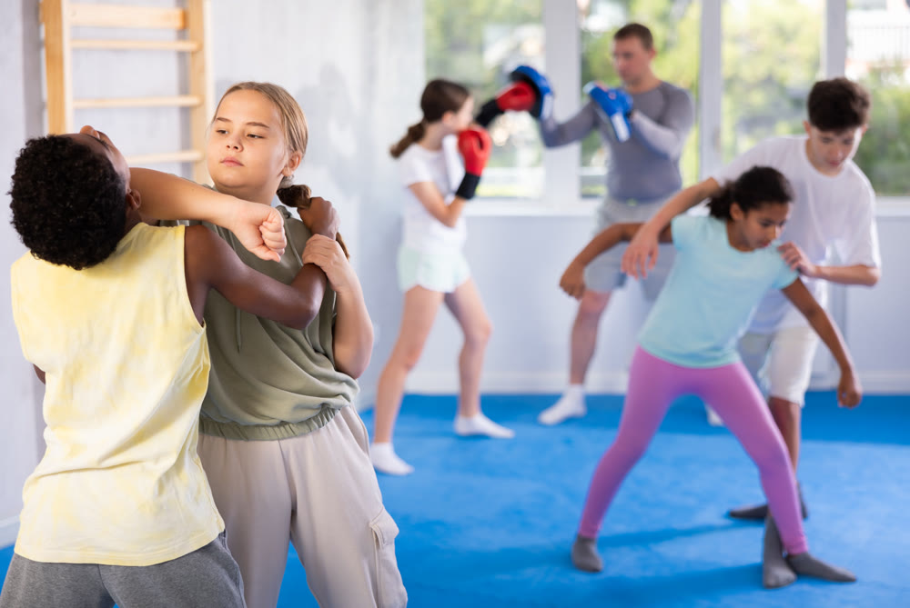 Boy and girl practicing self-defense techniques