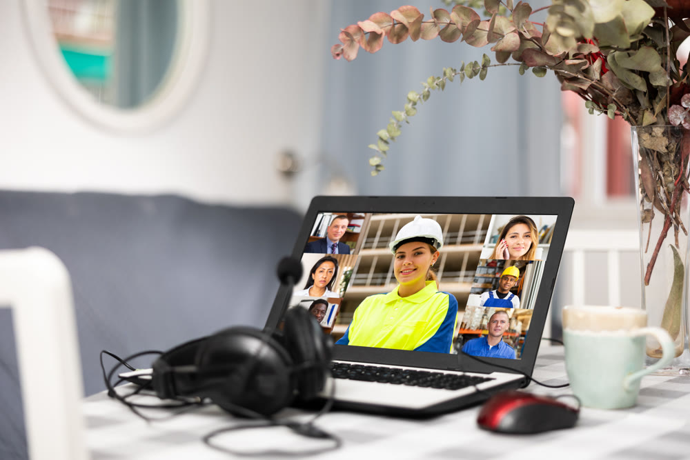 Laptop and headset on table at home, video conference