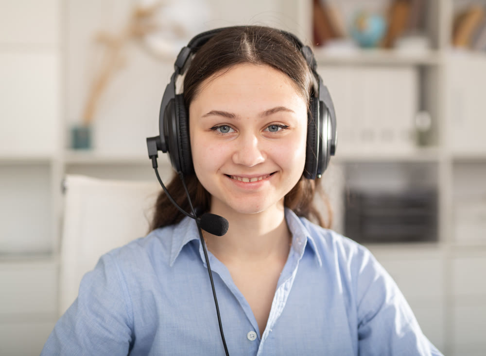 Happy call center operator talking with client
