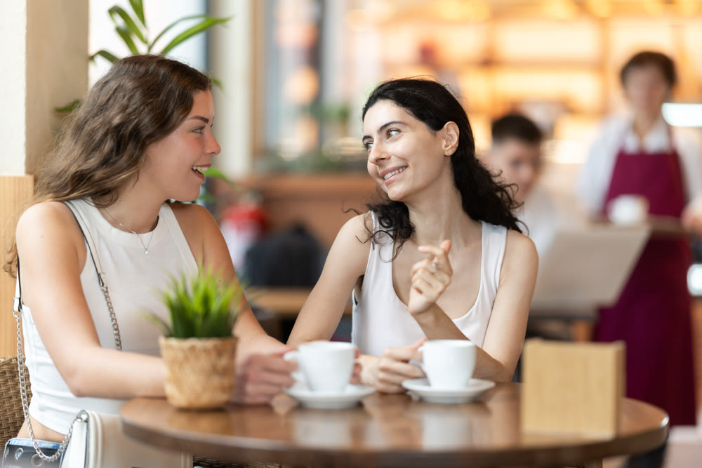 Two women sitting in a coffee shop talking