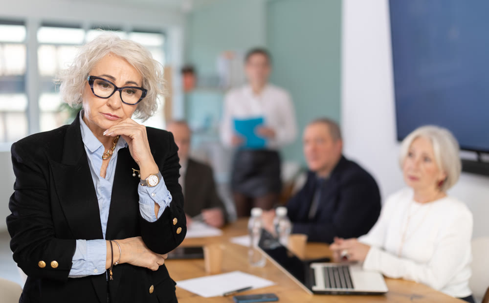 Upset senior female conference participant or partner is reprimanded