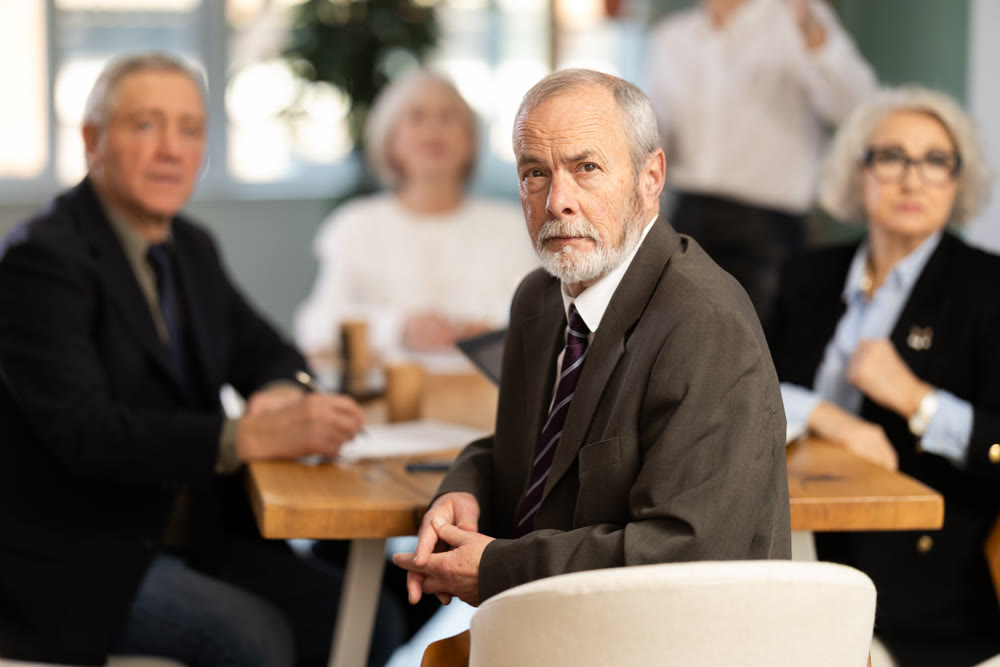 Girl with remote controller tell material, speaks to mature precursors of business group