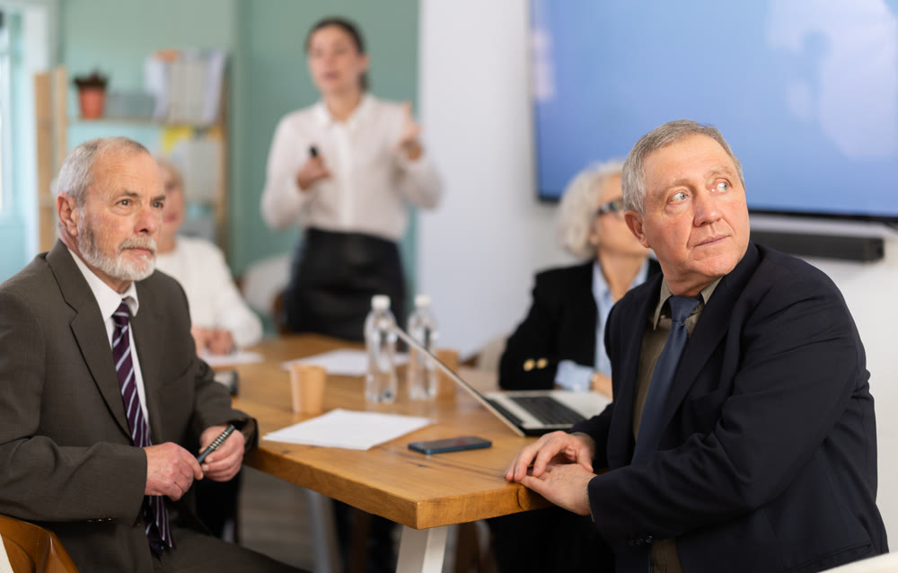 Businessman watching presentation while gathering in meeting room