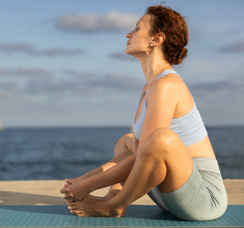 Warm-up and stretching of the body before yoga classes on ocean shore