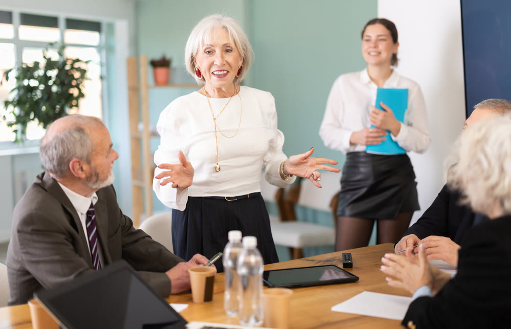 Woman company leader shares good news for her employees. Everyone is happy with the salary increase.