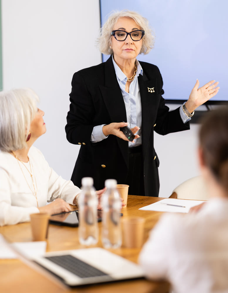 Elderly woman presenting with remote control