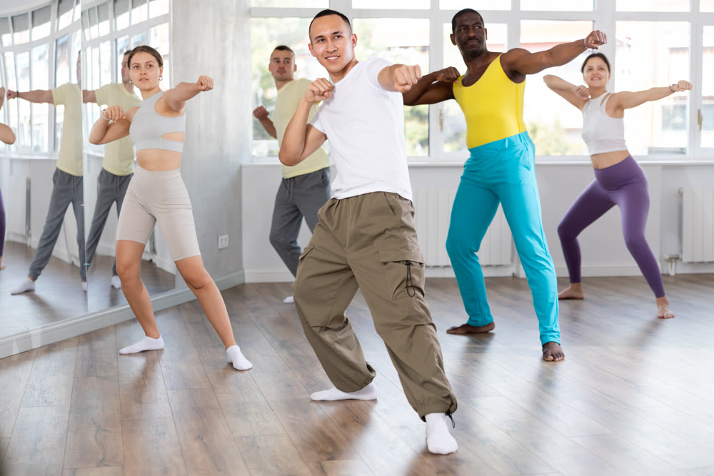 Young Asian man practicing Capoeira dance in training hall