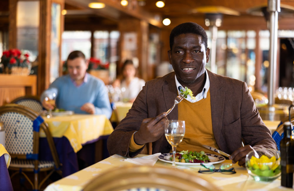 African-american man eating in restaurant