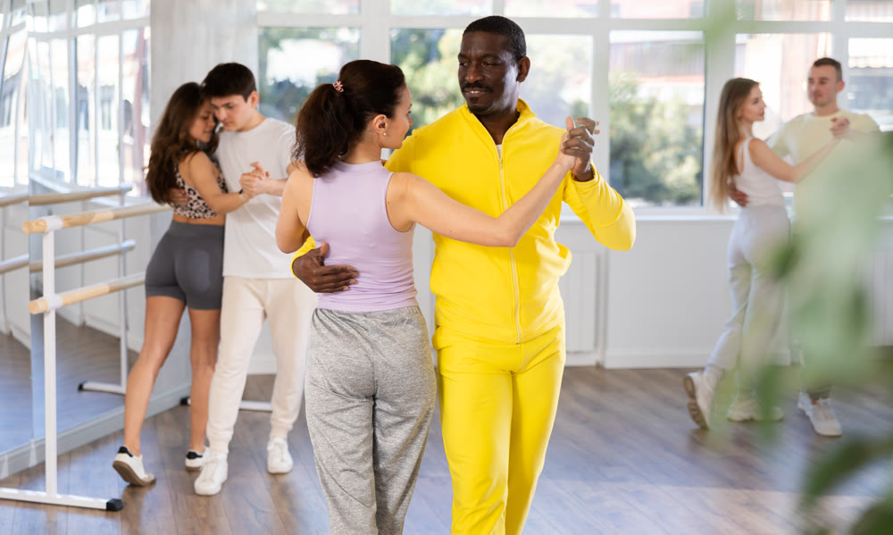 Club for those who like to dance for their own pleasure, non-professional dance performers enjoy waltz during rehearsal in dance studio