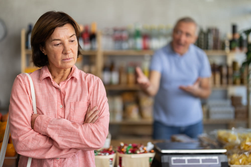Family quarrel between elderly husband and wife in grocery supermarket. Husband screams at her wife