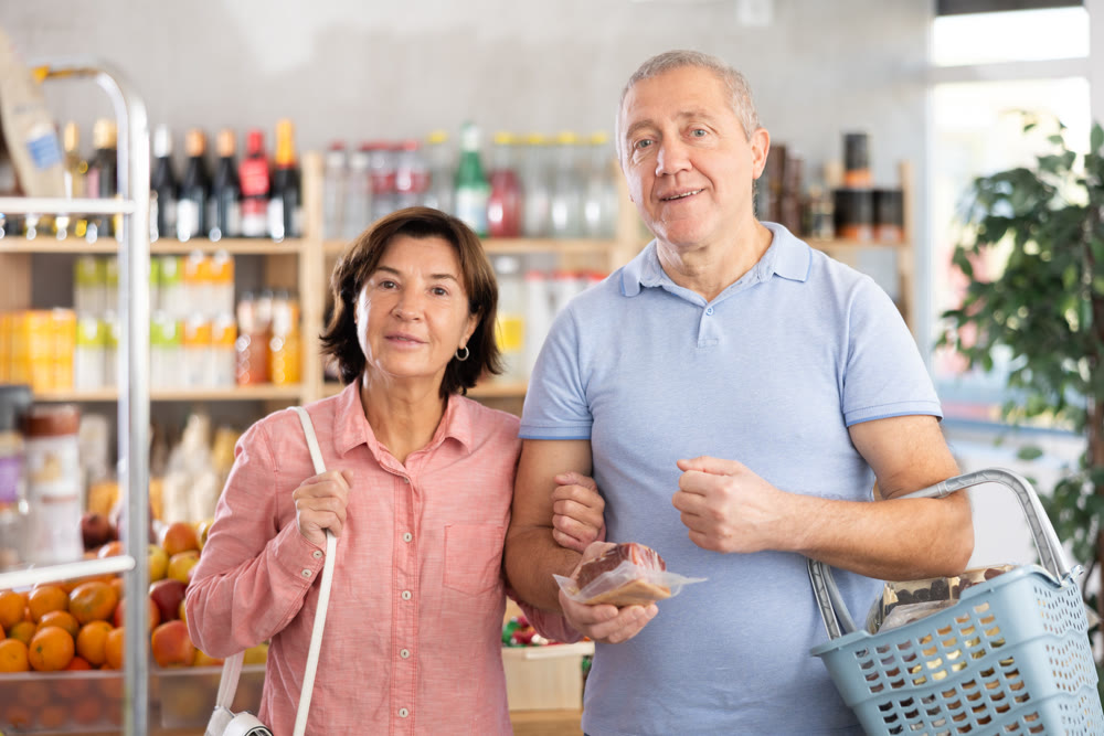 Senior family couple is looking for fresh produce together in grocery supermarket