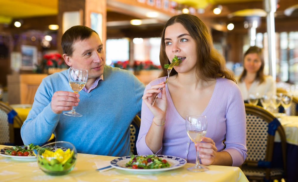 Couple chatting while having dinner in restaurant