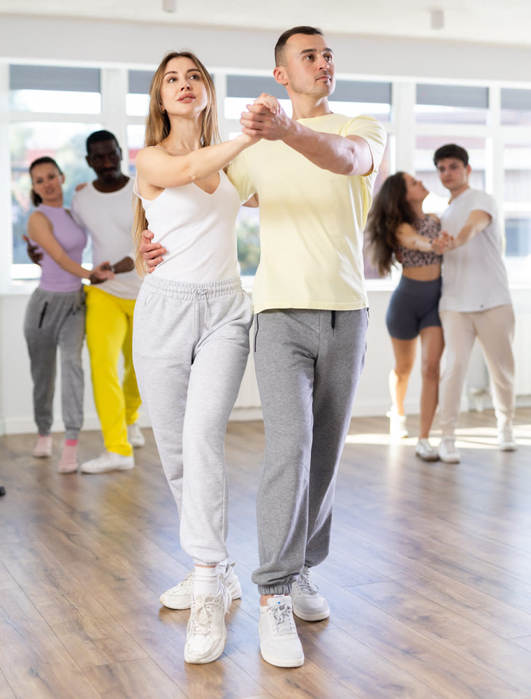 Young man and woman dancing latin dances