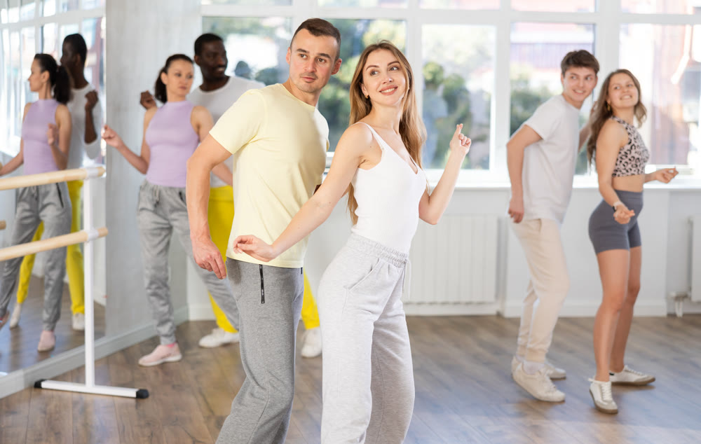 Couple young woman and man dancing twist