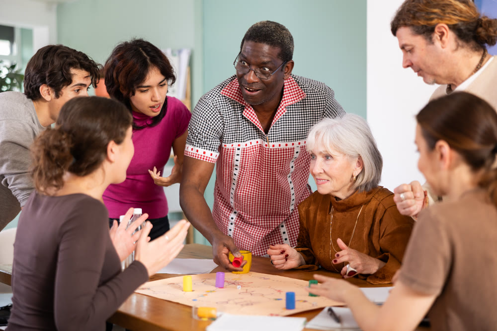 Group of different ages playing board game at table