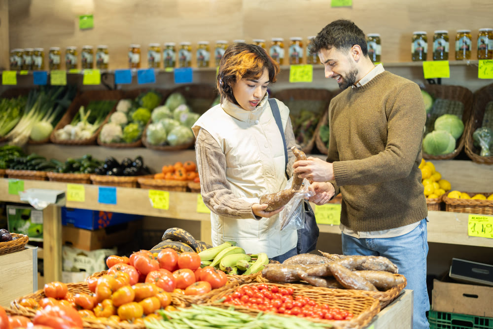 Married couple choose yucca root together at grocery supermarket