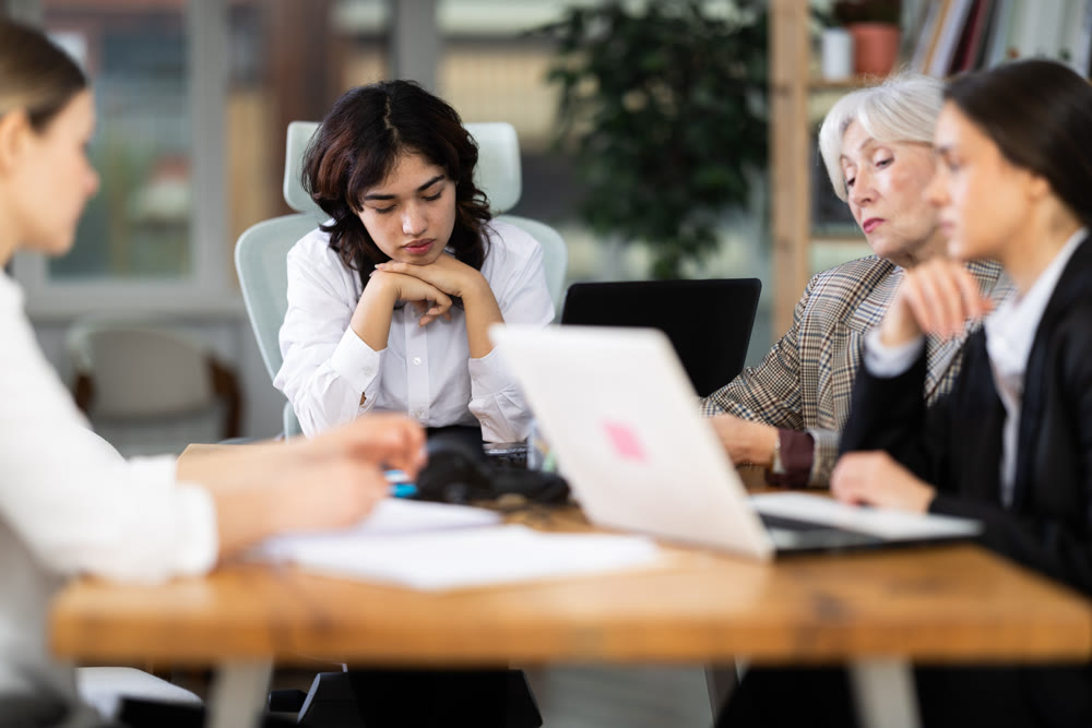 Tired female colleagues feeling tired during a long workday