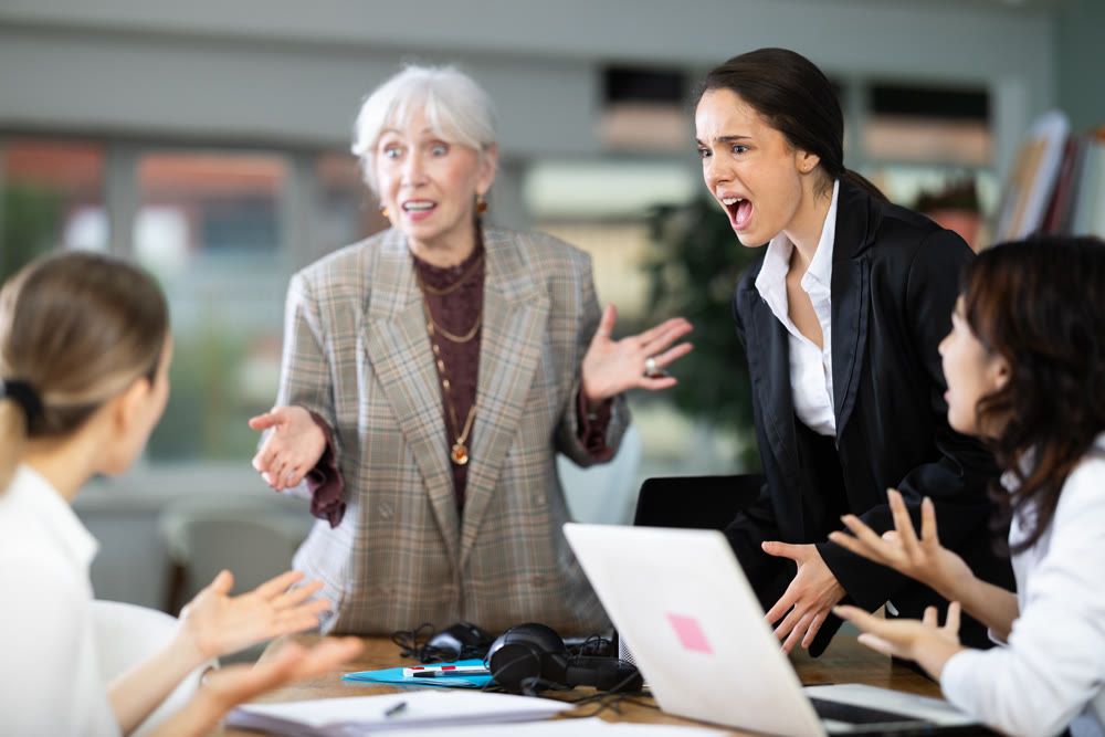 Group of female employees in office are shouting at each other