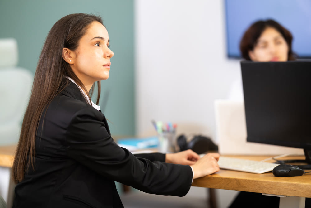 In study room, female business colleagues listens to lecture, look to presentation.