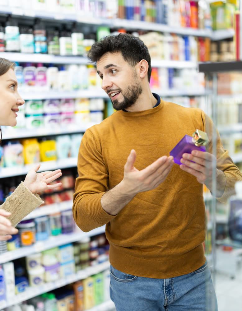 Couple spends time in store, looking for goods and select perfume