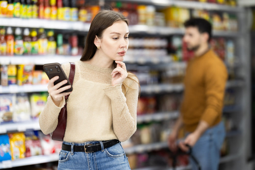 Female shopper are choosing something in food store