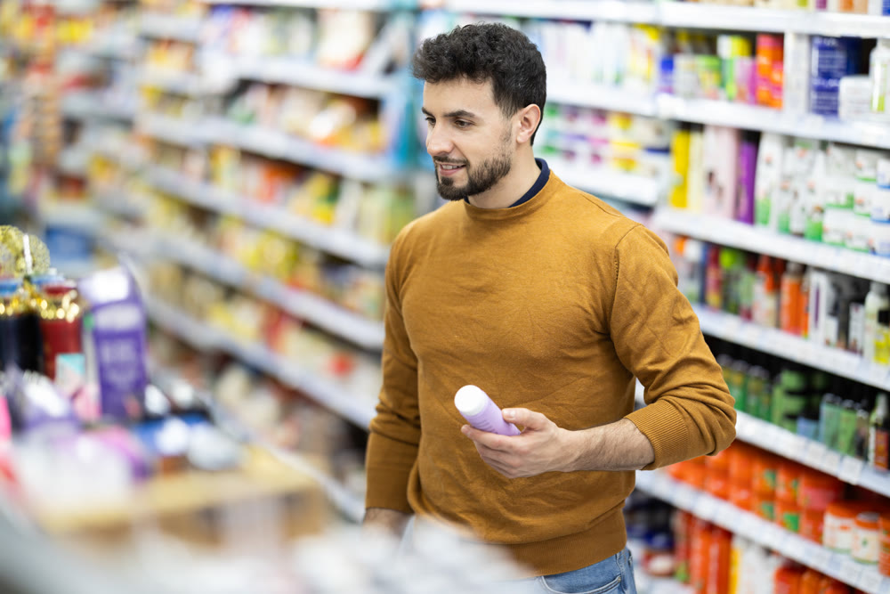 Man spends time in store, looking for goods and select care product