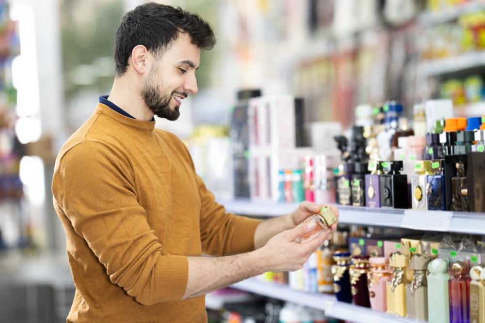 Young man chooses perfume in store