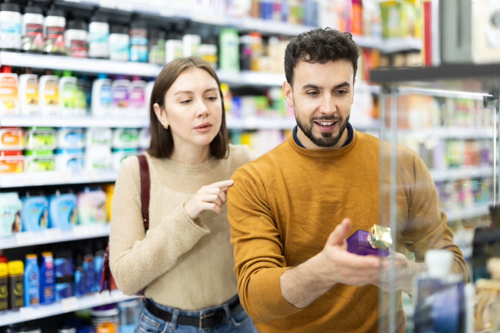 Young couple chooses perfume in store