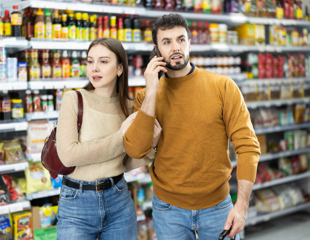 Couple shopping and man speak on mobile phone