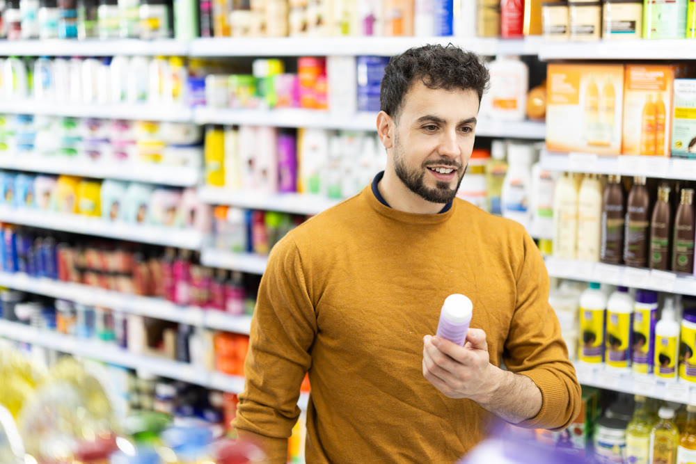 Man spends time in store, looking for goods and select care product