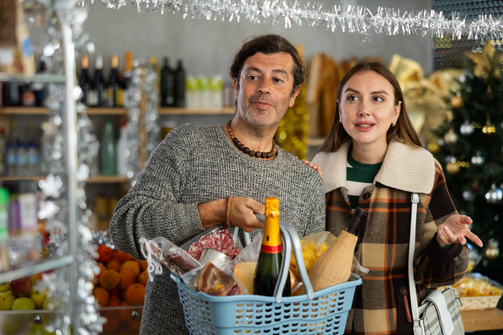 Husband and wife buy groceries at the supermarket for upcoming Christmas celebration