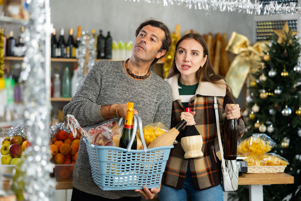 Husband and wife buy groceries at the supermarket for upcoming Christmas celebration
