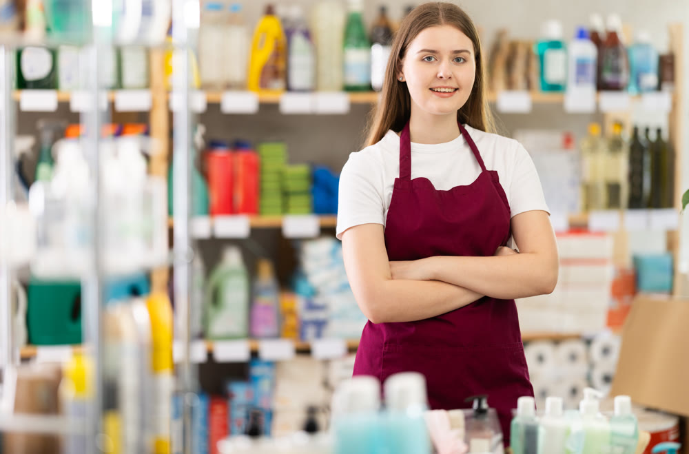 Girl store employee working in sales area