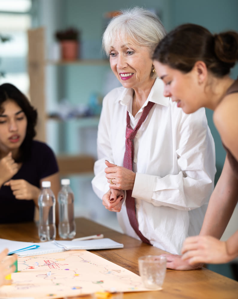 Group of women playing board game around a table