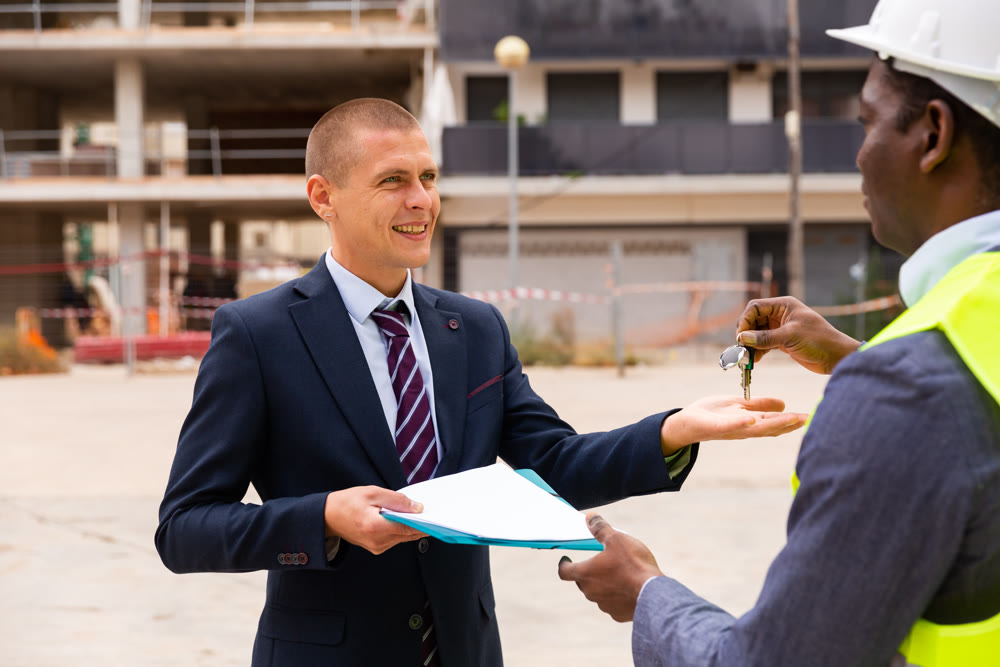 Man reciveing keys to new apartment from engineer