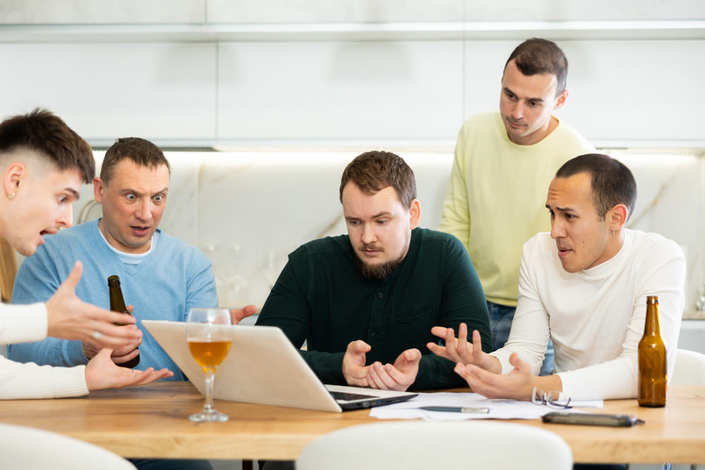 Concerned friends consoling man upset by online news