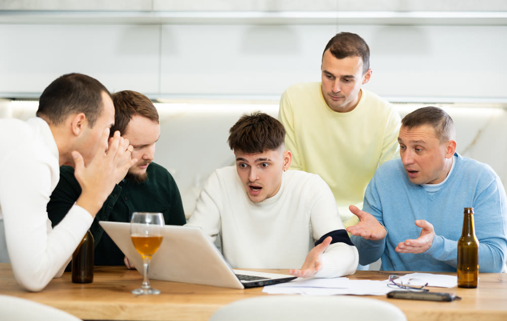 Concerned friends consoling man upset by online news