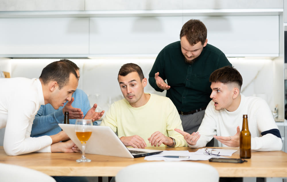 Concerned friends consoling man upset by online news